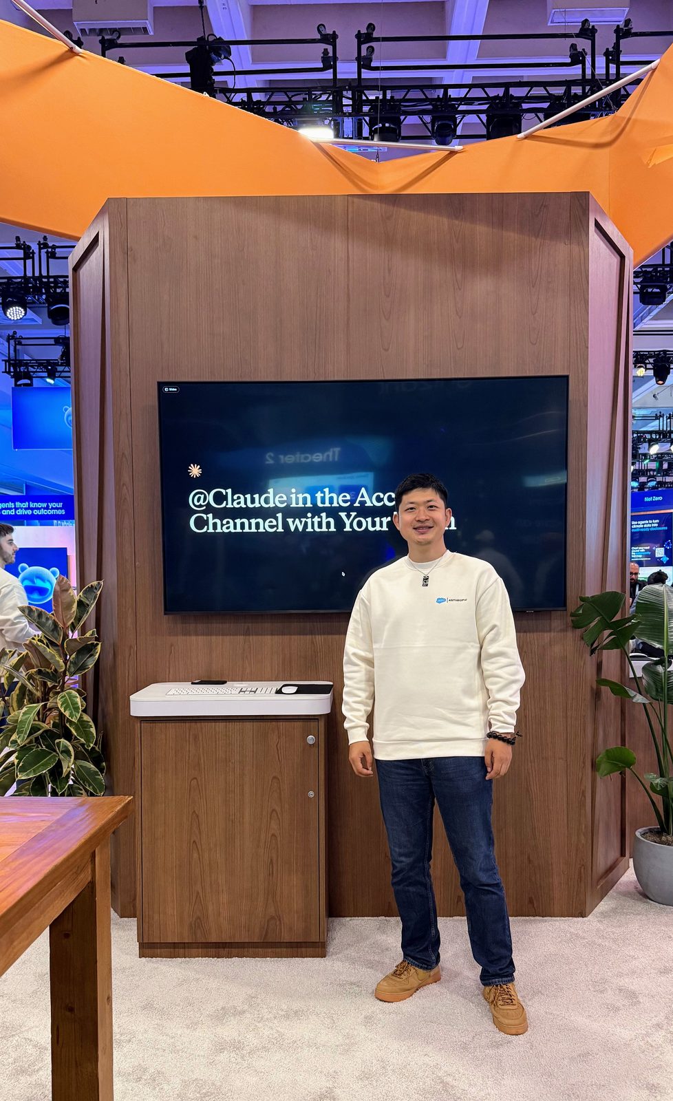 Kevin Bai at the Salesforce and Anthropic demo station, Claude Tag in a Slack channel on the screen