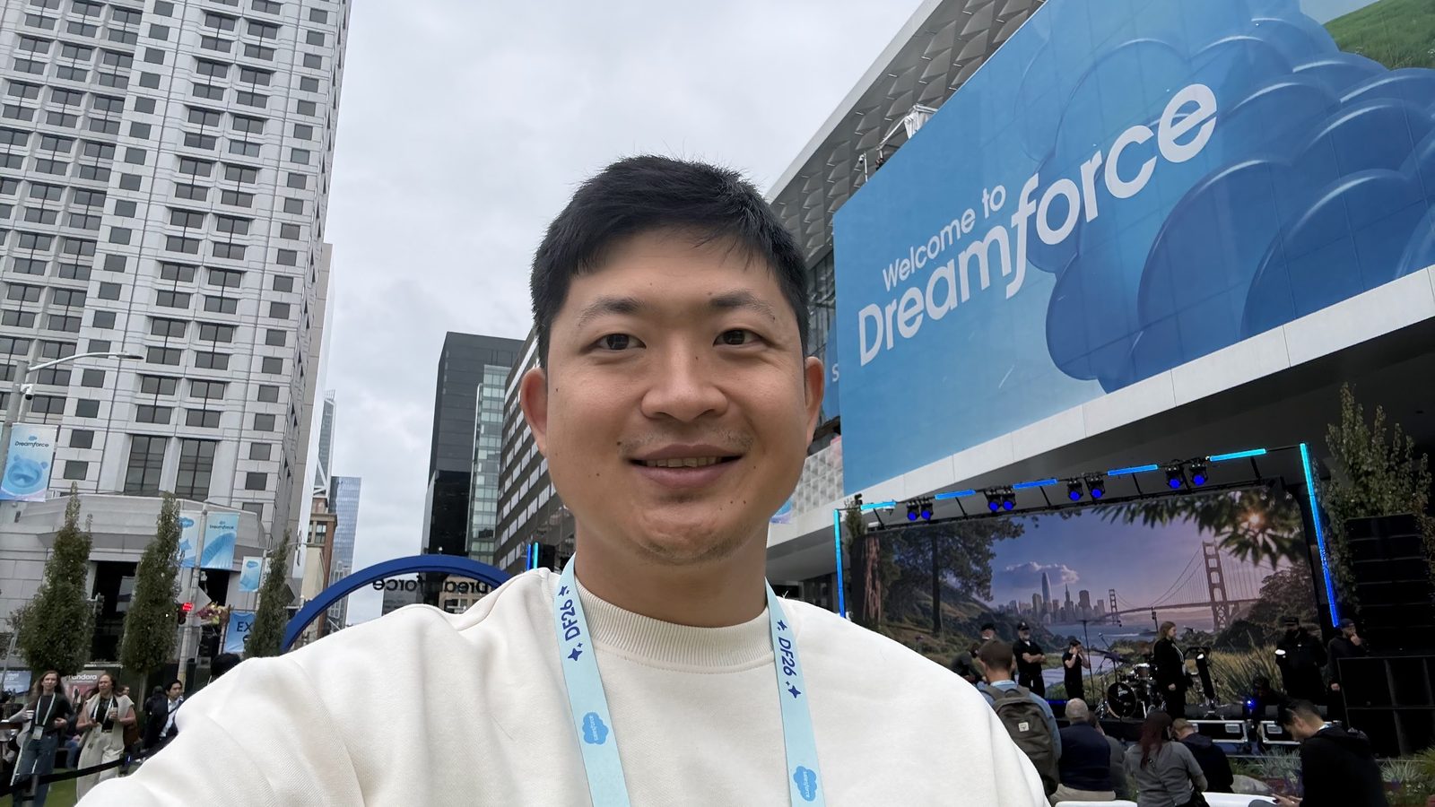 Kevin Bai outside Moscone under the Welcome to Dreamforce sign